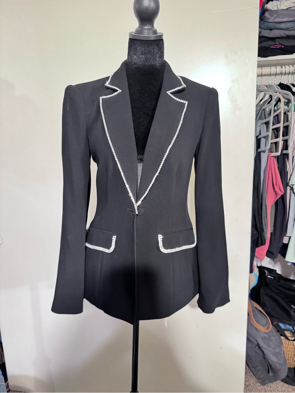 A vintage black Cinq à
Sept blazer with crystal embellishments.